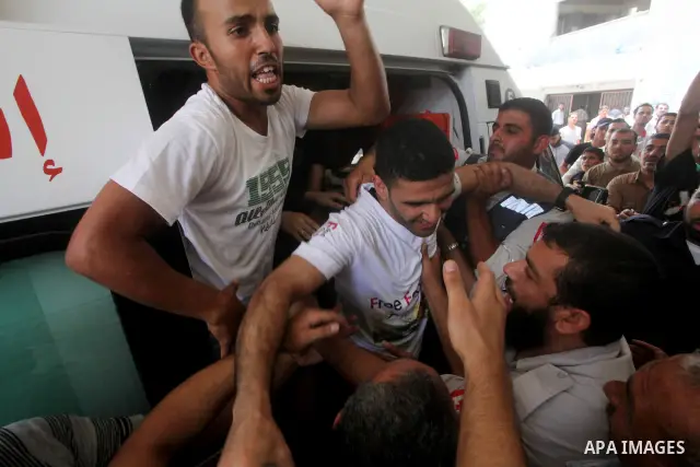 Palestinian soccer player Mahmoud Al-Sarsak waves to people upon his arrival in Gaza City July 10, 2012. Israel released the Gaza soccer player on Tuesday in a deal to end his intermittent four-month hunger strike after...