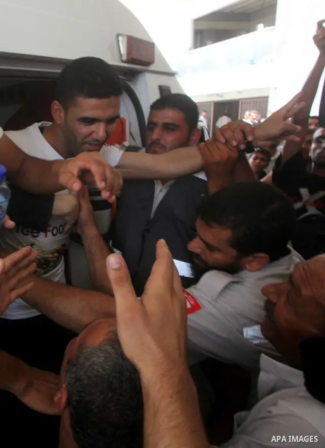Palestinian soccer player Mahmoud Al-Sarsak waves to people upon his arrival in Gaza City July 10, 2012. Israel released the Gaza soccer player on Tuesday in a deal to end his intermittent four-month hunger strike after...