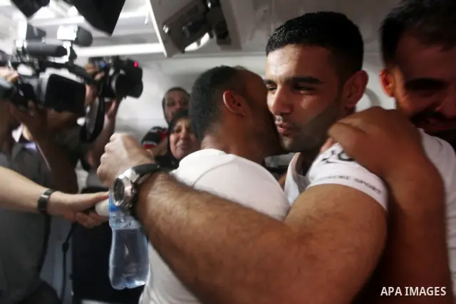 Palestinian soccer player Mahmoud Al-Sarsak greets people upon his arrival in Gaza City July 10, 2012. Israel released the Gaza soccer player on Tuesday in a deal to end his intermittent four-month hunger strike after he...