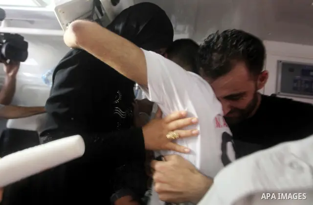 Palestinian soccer player Mahmoud Al-Sarsak greets people upon his arrival in Gaza City July 10, 2012. Israel released the Gaza soccer player on Tuesday in a deal to end his intermittent four-month hunger strike after he...