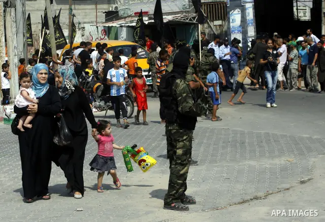 Palestinian militants of Islamic Jihad movement stand attention as Palestinian soccer player Mahmoud Al-Sarsak arrives to Rafah, southern Gaza strip on July 10, 2012 upon his release from Israeli prison. Sarsak staged a...