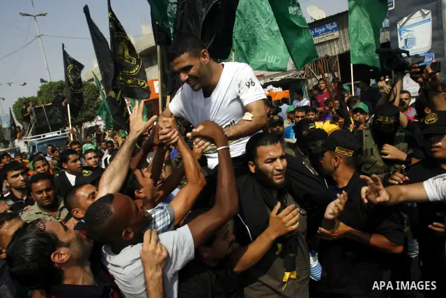 Palestinian soccer player Mahmoud Al-Sarsak greets people upon his arrival to Rafah southern Gaza strip, July 10, 2012. Israel released the Gaza soccer player on Tuesday in a deal to end his intermittent four-month hunge...