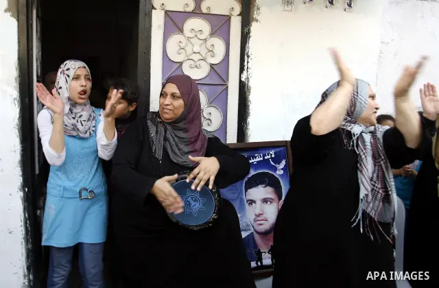 The family of Palestinian prisoner Mahmud Al-Sarsak celebrate in font of his home, as he arrives to Rafah southern Gaza strip on July 10, 2012 upon his release from Israeli prison. Sarsak staged a hunger strike of nearly...