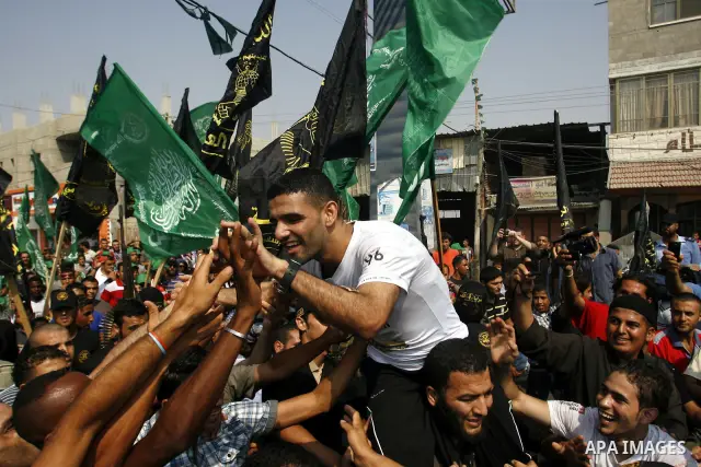 Palestinian soccer player Mahmoud Al-Sarsak greets people upon his arrival to Rafah southern Gaza strip, July 10, 2012. Israel released the Gaza soccer player on Tuesday in a deal to end his intermittent four-month hunge...