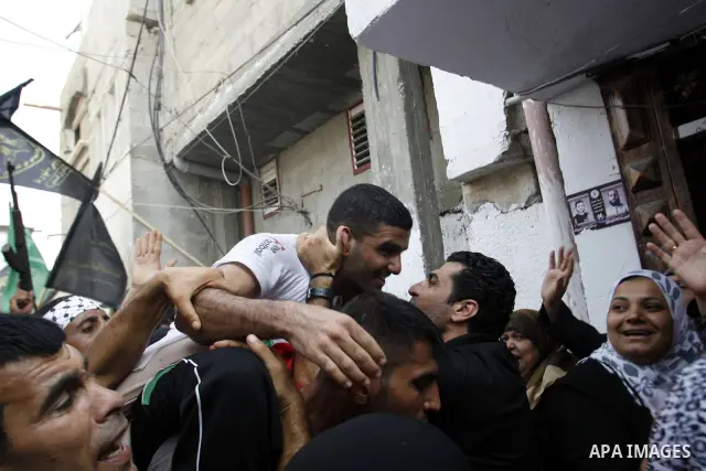 Palestinian soccer player Mahmoud Al-Sarsak greets people upon his arrival to Rafah southern Gaza strip, July 10, 2012. Israel released the Gaza soccer player on Tuesday in a deal to end his intermittent four-month hunge...