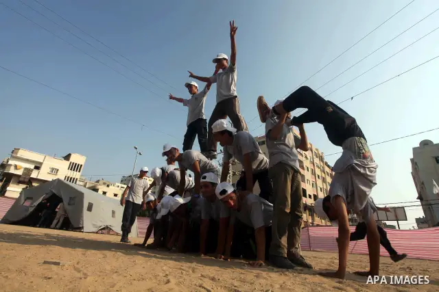 Palestinian children take part in a summer camp organized by Hamas movement at Shati refugee camp in Gaza City July 10, 2012. Hamas movement organized dozens of summer camps for Palestinian children during the period of...