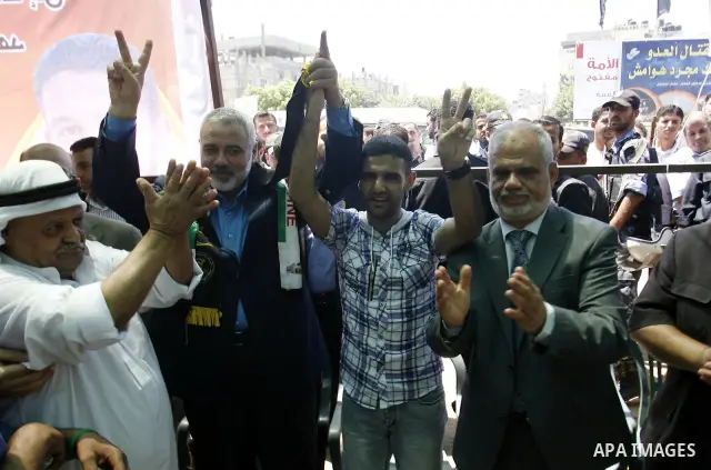 Palestinian Prime Minister in the Gaza Strip, Ismail Haniyeh meets with Palestinian football player Mahmud Sarsak, who staged a hunger strike of nearly three months while in Israeli jail, in the southern Gaza Strip on Ju...