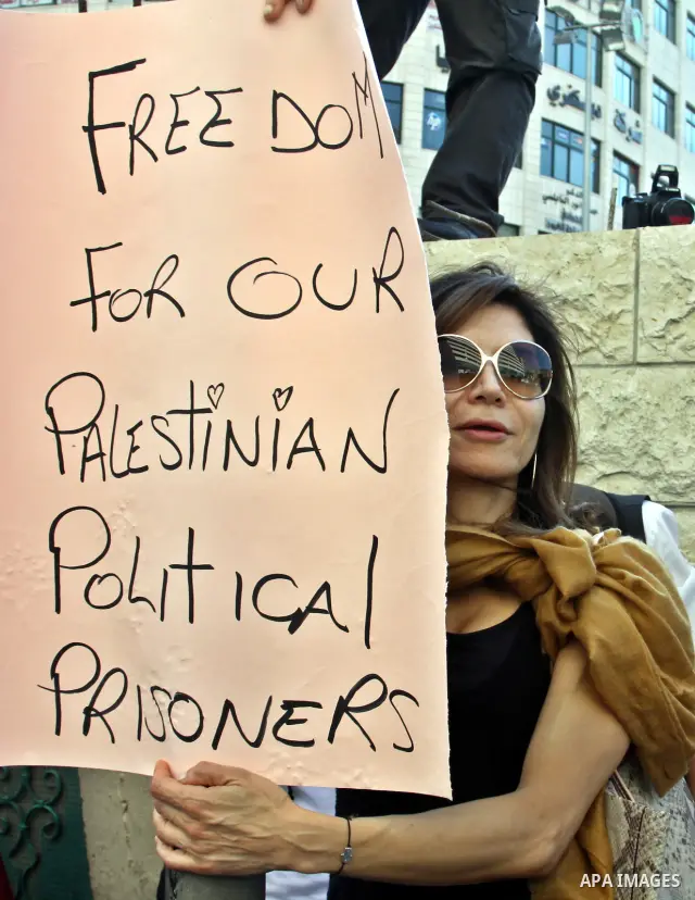 Palestinian protestors hold pictures of Palestinian prisoners in Israeli jails whose are still refusing food for after a deal was made to end a mass prisoner hunger strike, during a demonstration in their support, in the...