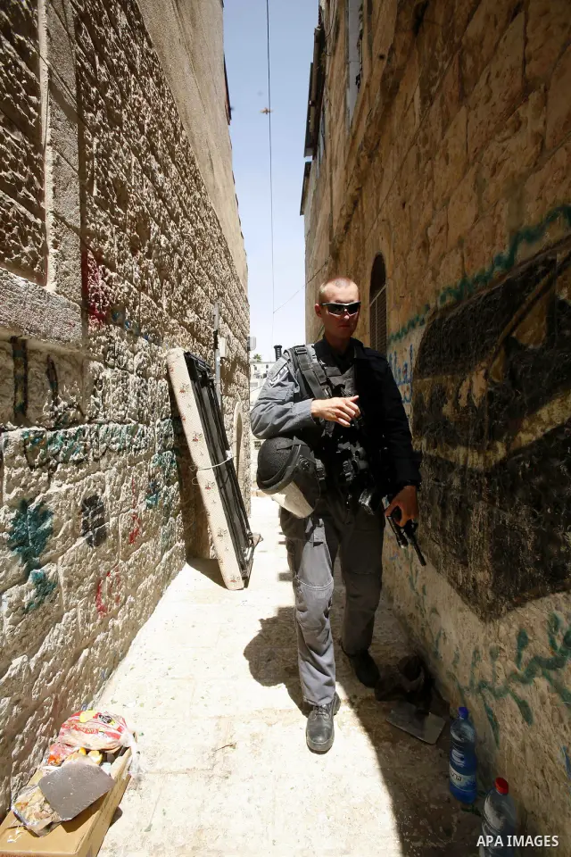 Israeli police officers oversight evacuation process of a Palestinian house in Jerusalem's old city on July. 11,2012 after the Palestinian family receive a notification to evacuate their house. Photo by Mahfouz Abu Turk