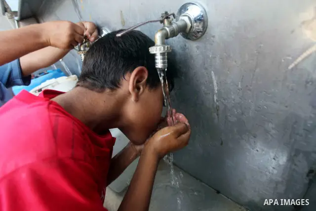 A Palestinian child drinks a potable water from a water purification station, in Deir al-Balah central Gaza Strip, on July 11. 2012. Palestinians suffer from the severe lack of potable water. Photo by Ashraf Amra