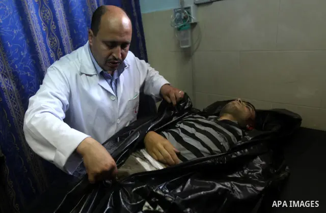 Palestinian medics wheel a Hamas militant into al-Shifa Hospital following an Israeli attack in Gaza City on July 12, 2012. A Palestinian militant from the ruling Hamas movement was killed and two others wounded on Thurs...