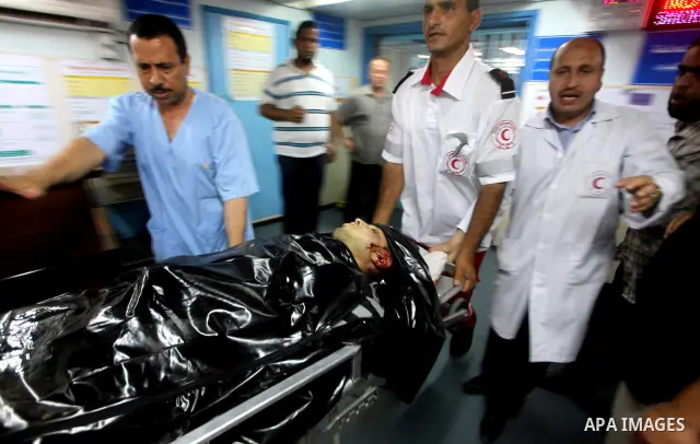 Palestinian medics wheel a Hamas militant into al-Shifa Hospital following an Israeli attack in Gaza City on July 12, 2012. A Palestinian militant from the ruling Hamas movement was killed and two others wounded on Thurs...