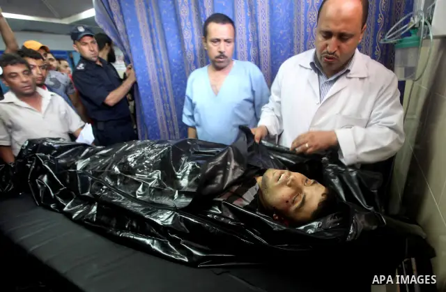 Palestinian medics wheel a Hamas militant into al-Shifa Hospital following an Israeli attack in Gaza City on July 12, 2012. A Palestinian militant from the ruling Hamas movement was killed and two others wounded on Thurs...