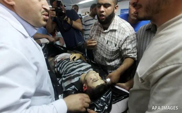 Palestinian medics wheel a Hamas militant into al-Shifa Hospital following an Israeli attack in Gaza City on July 12, 2012. A Palestinian militant from the ruling Hamas movement was killed and two others wounded on Thurs...