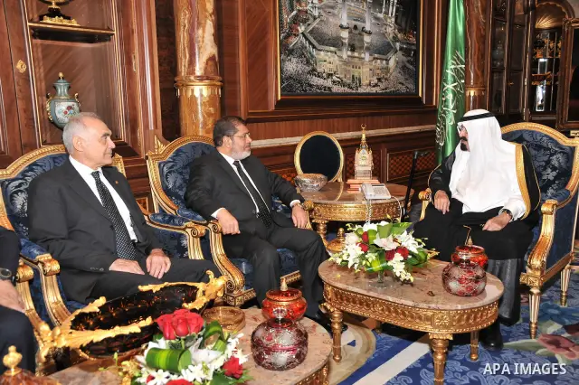 Saudi Arabia's King Abdullah bin Abdul Aziz (R) with Egypt's President Mohamed Morsi (C) and Foreign Minister Kamel Amr (L) during their meeting in Jeddah, Saudi Arabia, 11 July 2012. Egyptian President Morsi arrived 11...