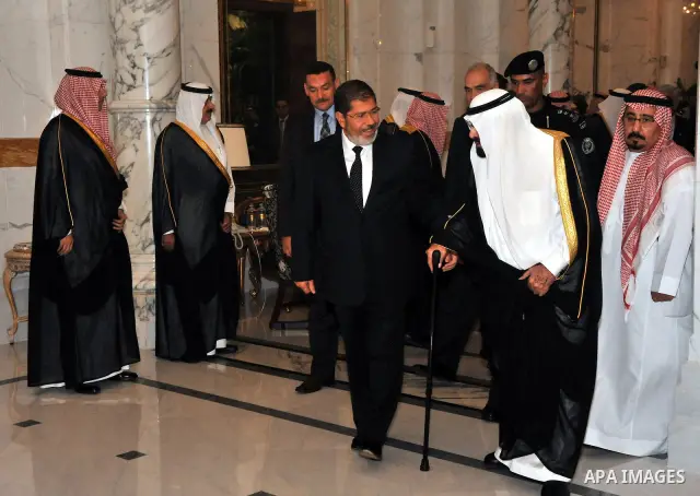 Egypt's President Mohamed Morsi (3-L) with Saudi Arabia's King Abdullah bin Abdul Aziz (R) in Jeddah, Saudi Arabia, 11 July 2012. Egyptian President Morsi arrived 11 July in Saudi Arabia on his first foreign trip in offi...