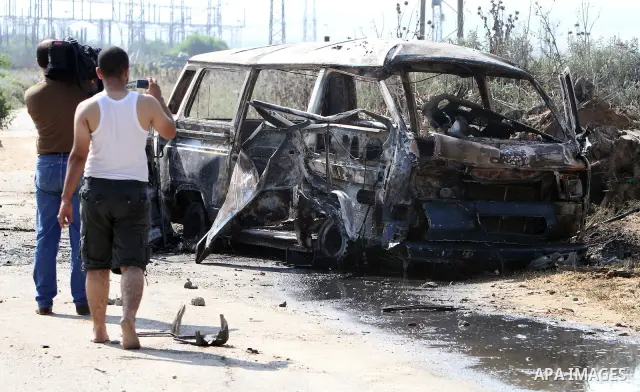 Palestinians inspect a destroyed vehicle following an Israeli bombing in Gaza City on July 12, 2012. A Palestinian was killed and others wounded after an Israeli air strike in al-Zeitoun area in the east of Gaza city on...