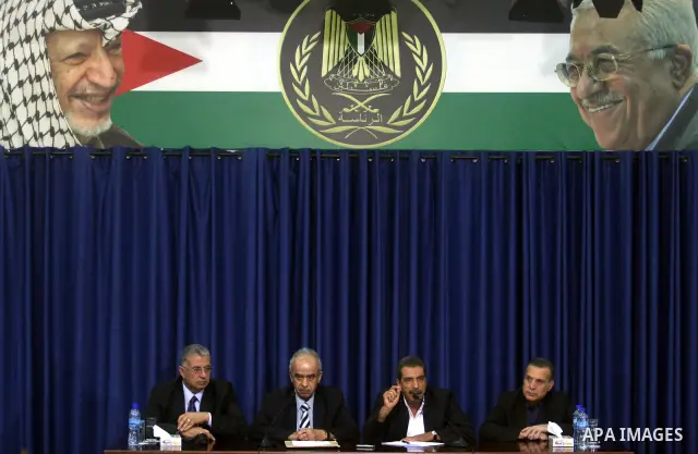 Palestinian Justice Minister Ali Mohanna, left, and one of late Yasser Arafat's doctors, Abdullah al-Bashir, right, hold a press conference with Palestinian official Tawfik Tirawi, in the West Bank city of Ramallah, Thur...