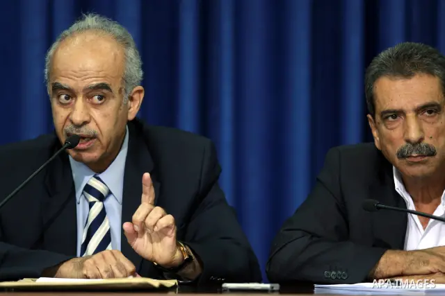 The chairman of the medical commission of Palestinian inquiry commission into the death of late Palestinian leader Yasser Arafat, Abdullah al-Basheer (L) with Palestinian official Tawfik Tirawi hold a press conference wi...