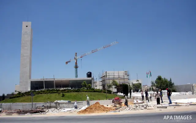 Workers walk outside the memorial building for the late Palestinian leader Yasser Arafat in the West Bank city of Ramallah on July, 12, 2012. Palestinian Justice Minister Ali Mohanna said Thursday investigators looking i...