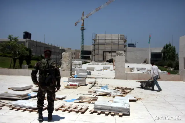 Workers walk outside the memorial building for the late Palestinian leader Yasser Arafat in the West Bank city of Ramallah on July, 12, 2012. Palestinian Justice Minister Ali Mohanna said Thursday investigators looking i...
