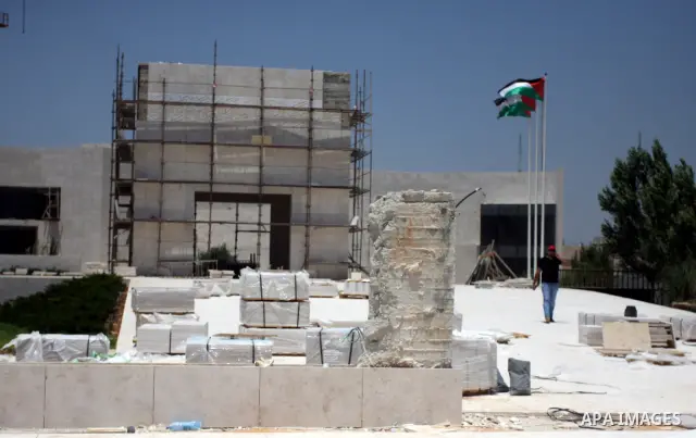 Workers walk outside the memorial building for the late Palestinian leader Yasser Arafat in the West Bank city of Ramallah on July, 12, 2012. Palestinian Justice Minister Ali Mohanna said Thursday investigators looking i...