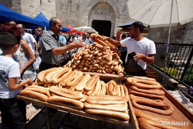 Palestinians shop at a traditional market following Friday prayers, in the old city of Jerusalem on July 13, 2012. Photo by Mahfouz Abu Turk