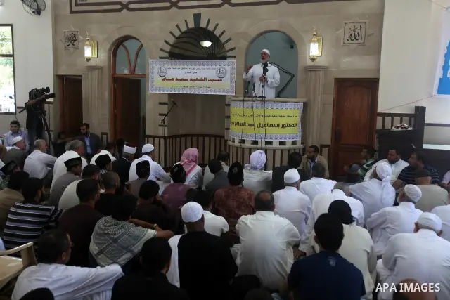 Palestinians listen to Palestinian Prime Minister in Gaza Ismail Haniyeh speech during Friday prayer in Gaza City on 13 July 2012.. Photo by Majdi Fathi