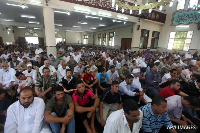 Palestinians listen to Palestinian Prime Minister in Gaza Ismail Haniyeh speech during Friday prayer in Gaza City on 13 July 2012.. Photo by Majdi Fathi