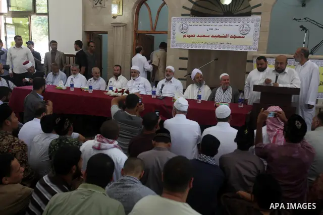 Palestinians listen to Palestinian Prime Minister in Gaza Ismail Haniyeh speech during Friday prayer in Gaza City on 13 July 2012. Photo by Majdi Fathi