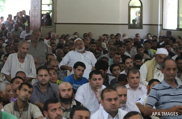 Palestinians listen to Palestinian Prime Minister in Gaza Ismail Haniyeh speech during Friday prayer in Gaza City on 13 July 2012.. Photo by Majdi Fathi
