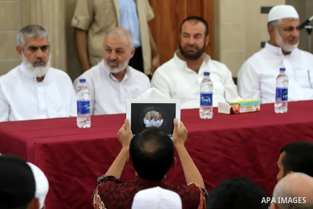 Palestinians listen to Palestinian Prime Minister in Gaza Ismail Haniyeh speech during Friday prayer in Gaza City on 13 July 2012. Photo by Majdi Fathi
