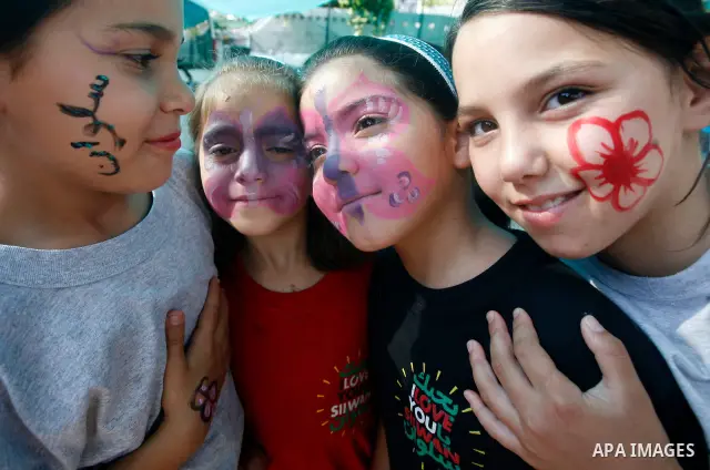 Palestinian children paint national flags on their faces during a rally on 13 July, 2012 in the east Jerusalem neighborhood of Silwan against Jewish settlement and the judaization in Palestinian districts of the holy cit...