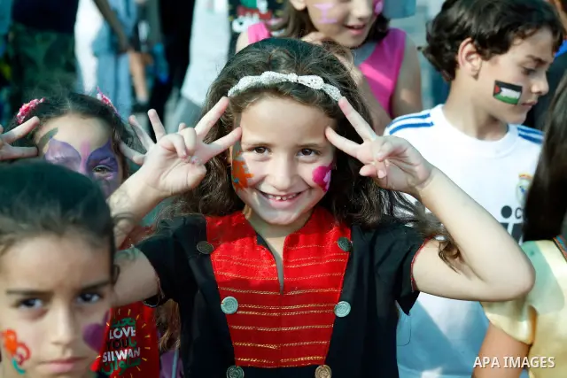 A Palestinian child flashes a victory sign during a rally on 13 July, 2012 in the east Jerusalem neighborhood of Silwan against Jewish settlement and the judaization in Palestinian districts of the holy city. Photo by Ma...