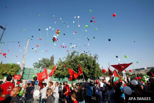Palestinian children hold balloons and placards during a rally on 13 July, 2012 in the east Jerusalem neighborhood of Silwan against Jewish settlement and the judaization in Palestinian districts of the holy city. Photo...