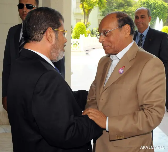 Egyptian President Mohamed Morsi (L) greeting Tunisian President Moncef Marzouki (R) at the presidential palace, in Cairo, Egypt, 13 July 2012. Marzouki is the first head of state to meet with Morsi in Cairo since he was...