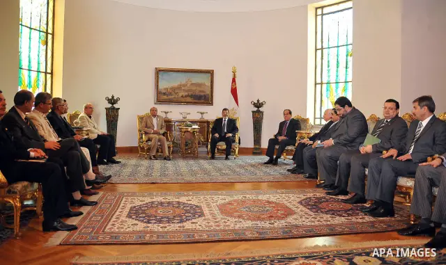 Tunisian President Moncef Marzouki, left, meets with Egyptian President Mohammed Morsi, right, at the Presidential palace in Cairo, Egypt, Friday, July 13, 2012. The presidents of Egypt and Tunisia pledge to open a new c...