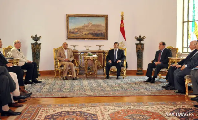Tunisian President Moncef Marzouki, left, meets with Egyptian President Mohammed Morsi, right, at the Presidential palace in Cairo, Egypt, Friday, July 13, 2012. The presidents of Egypt and Tunisia pledge to open a new c...