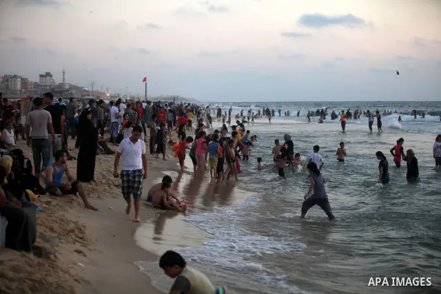 Palestinians enjoy swimming in the sea at Gaza beach on 13 July 2012 in Gaza City. Photo by Majdi Fathi