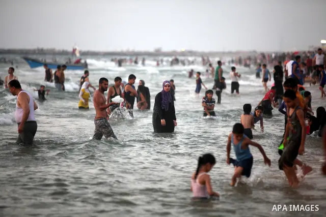 Palestinians enjoy swimming in the sea at Gaza beach on 13 July 2012 in Gaza City. Photo by Majdi Fathi