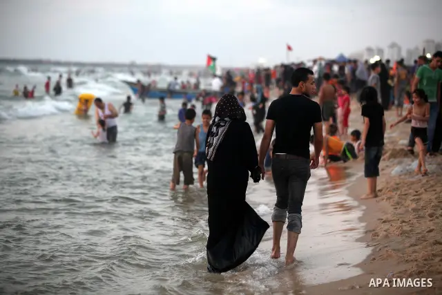 Palestinians enjoy swimming in the sea at Gaza beach on 13 July 2012 in Gaza City. Photo by Majdi Fathi