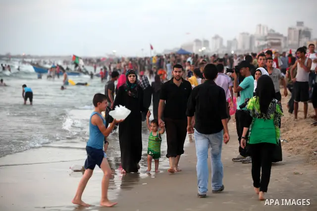 Palestinians promenade at Gaza beach on 13 July 2012 in Gaza City. Photo by Majdi Fathi