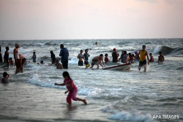 Palestinians enjoy swimming in the sea at Gaza beach on 13 July 2012 in Gaza City. Photo by Majdi Fathi