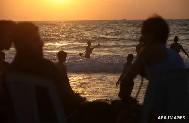 Palestinians enjoy swimming in the sea at Gaza beach on 13 July 2012 in Gaza City. Photo by Majdi Fathi