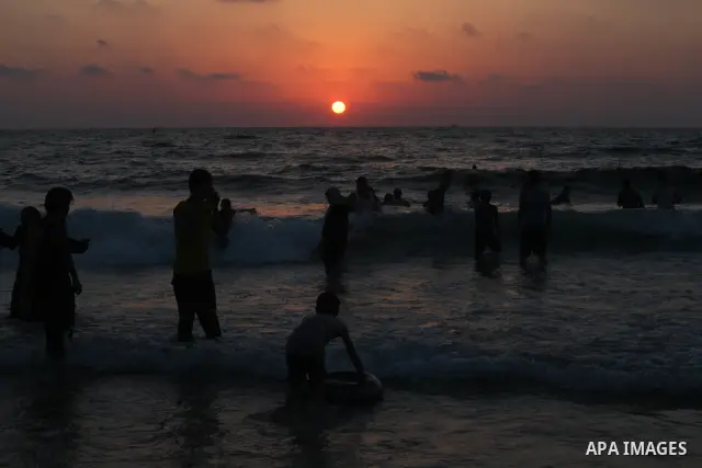 Palestinians enjoy swimming in the sea at Gaza beach on 13 July 2012 in Gaza City. Photo by Majdi Fathi