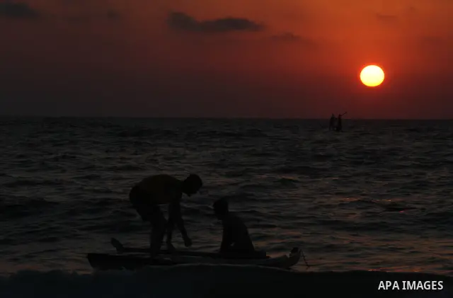 Palestinians enjoy swimming in the sea at Gaza beach on 13 July 2012 in Gaza City. Photo by Majdi Fathi