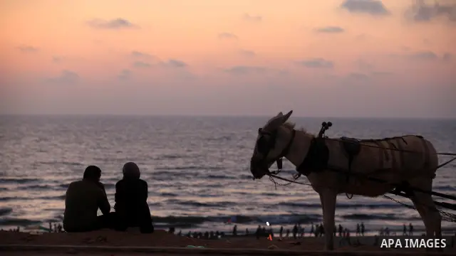 Palestinians promenade at Gaza beach on 13 July 2012 in Gaza City. Photo by Majdi Fathi