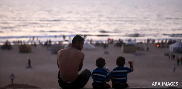 Palestinians promenade at Gaza beach on 13 July 2012 in Gaza City. Photo by Majdi Fathi
