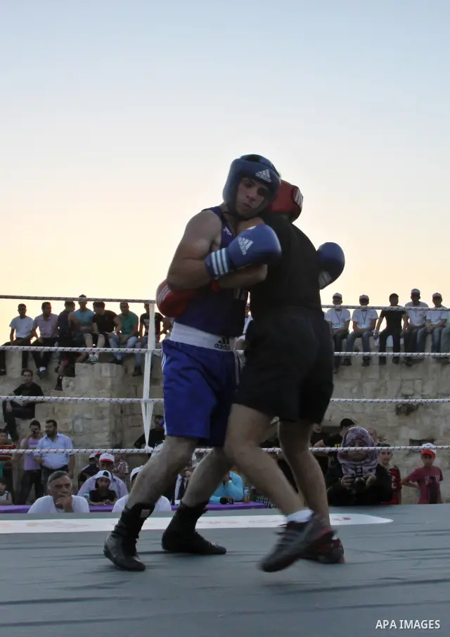 Palestinian boxing players fight during a friendly match in the West Bank city of Nablus, on 13 July 2012. Palestinian boxing union built a new international racetrack in Nablus. Photo by Nedal Eshtayah