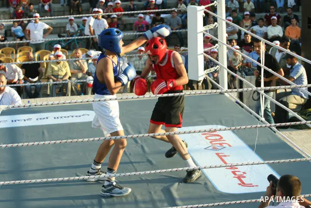 Palestinian boxing players fight during a friendly match in the West Bank city of Nablus, on 13 July 2012. Palestinian boxing union built a new international racetrack in Nablus. Photo by Nedal Eshtayah